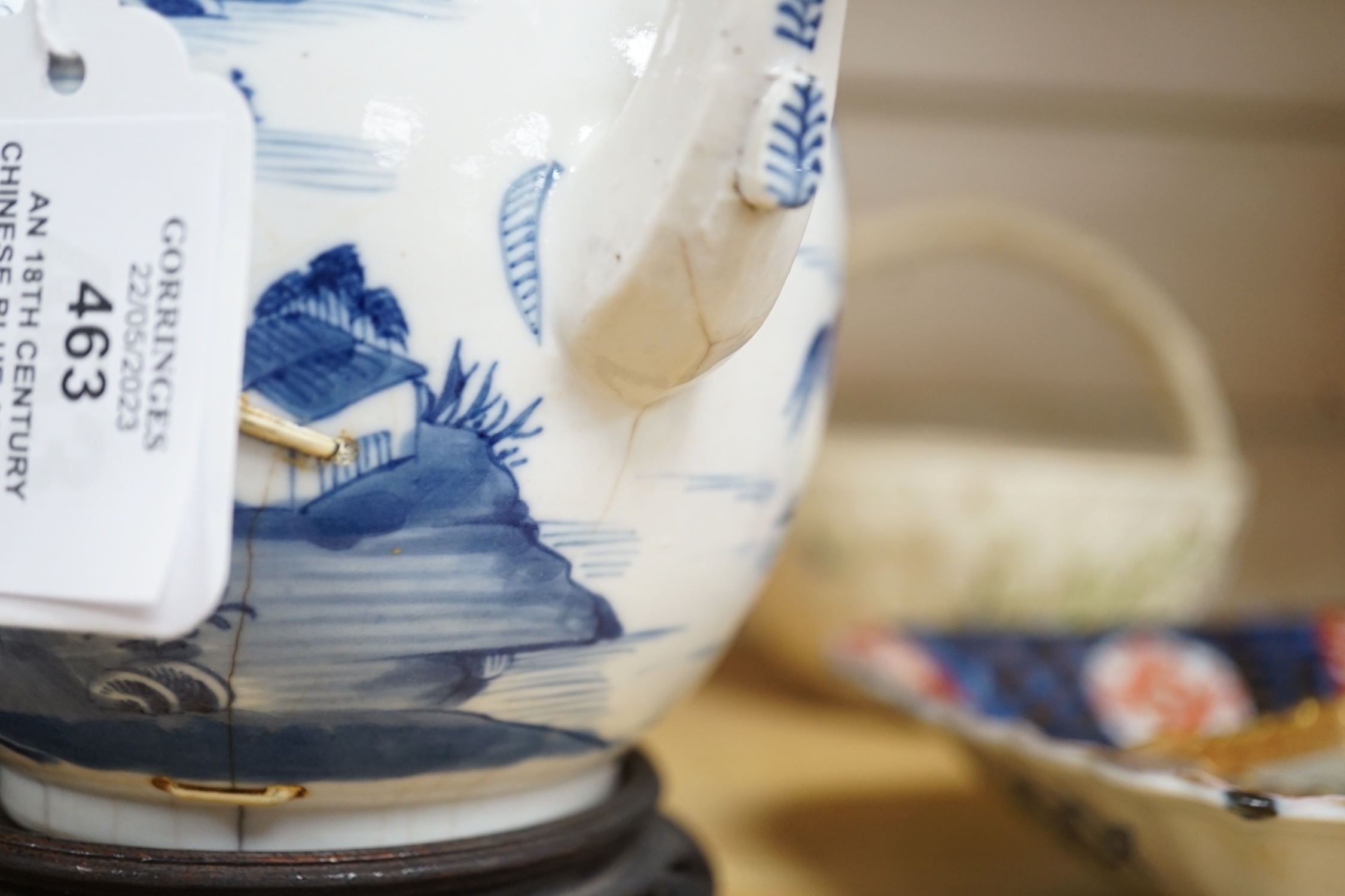 An 18th century Chinese blue and white teapot and cover, with hardwood stand, 19cm total height